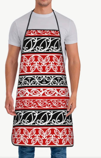 Person wearing a red, black, and white patterned apron on a white background